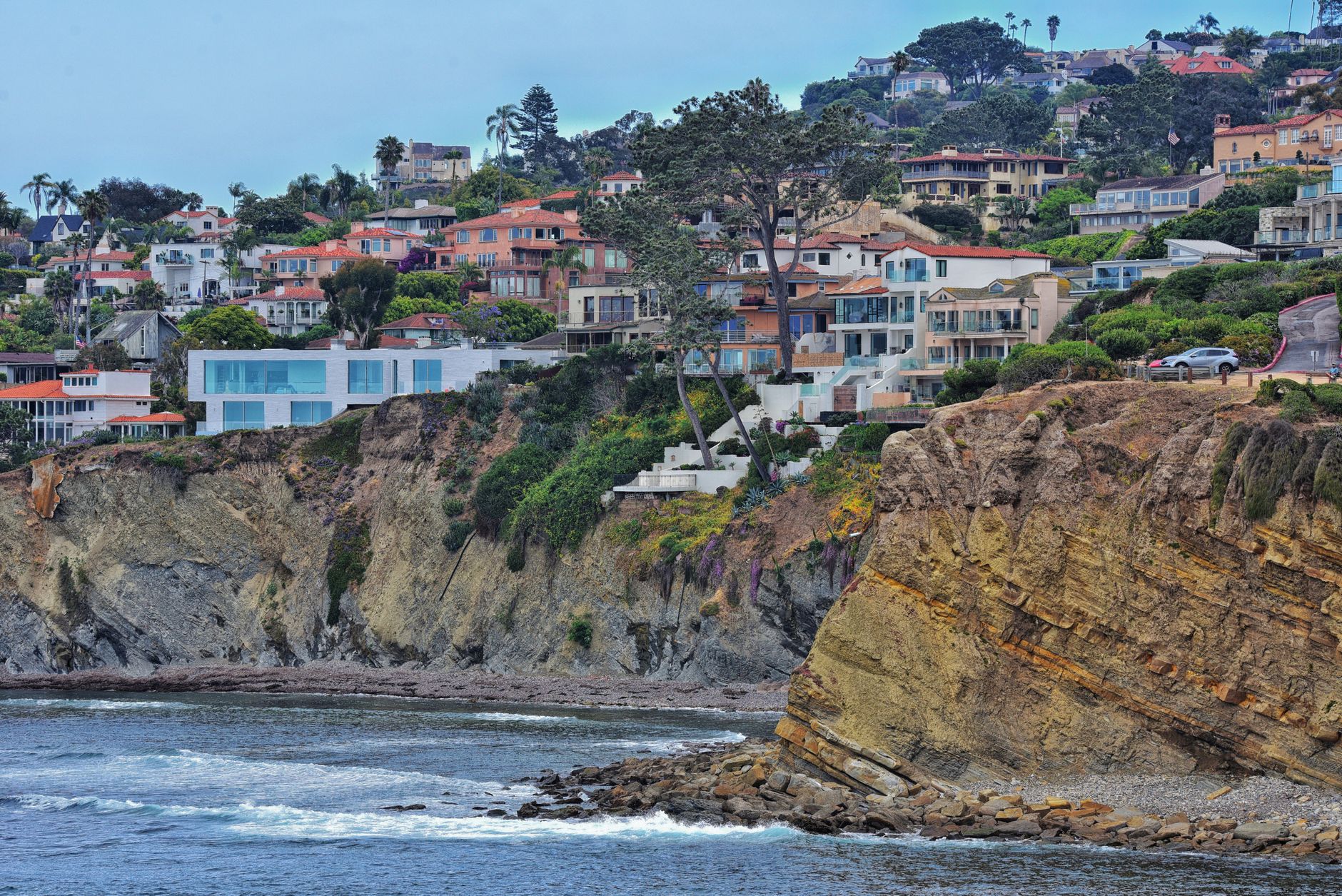 Coastal cliffs and hillside homes overlooking the ocean in San Diego, California.