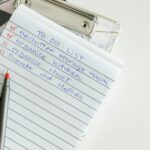 A neatly written to-do list on lined paper with a pen, perfect for organizing tasks.