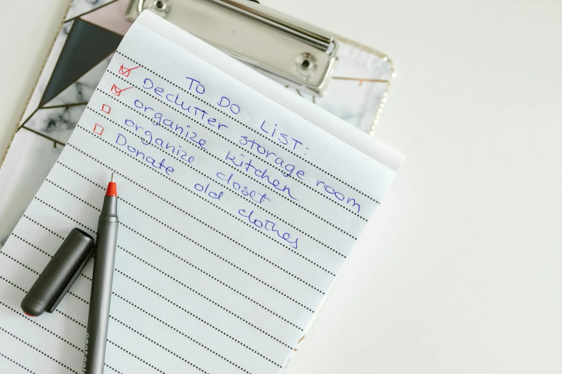 A neatly written to-do list on lined paper with a pen, perfect for organizing tasks.